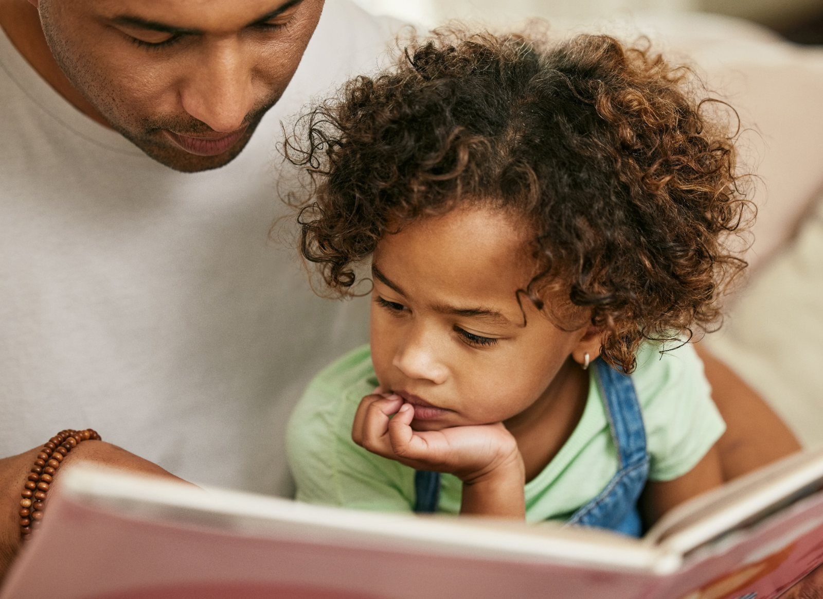 A parent and child reading together, close and unhurried